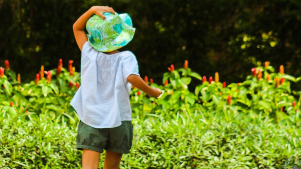 Child in green hat on a scavenger hunt