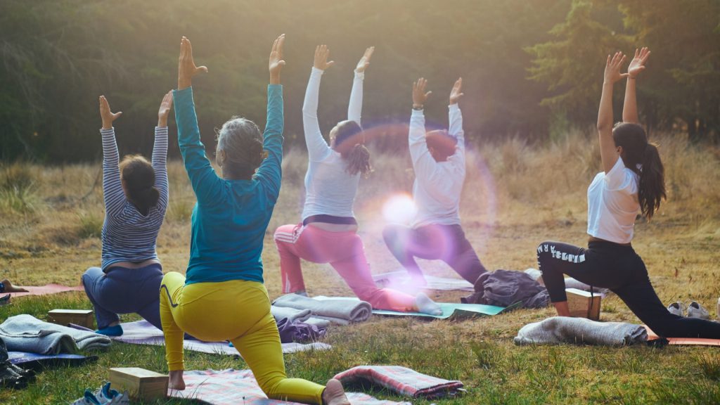 group of women doing yoga outside