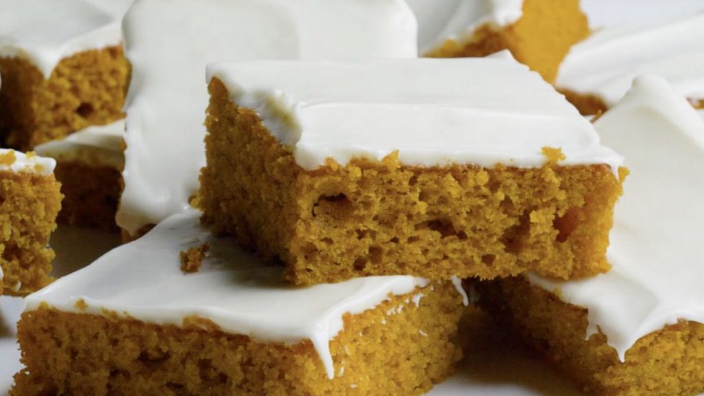 plated stack of pumpkin bars with cream cheese frosting