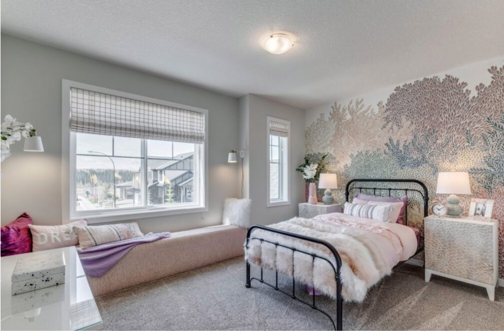 kids bedroom in one of westcreek homes models with a wallpaper feature wall and bench window seating