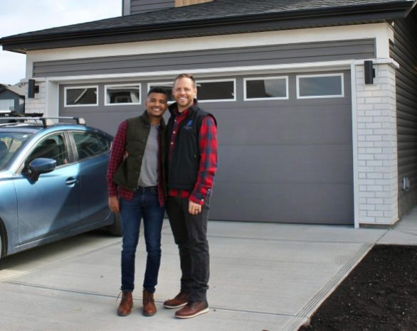 proud new homeowners smiling in front of their new home