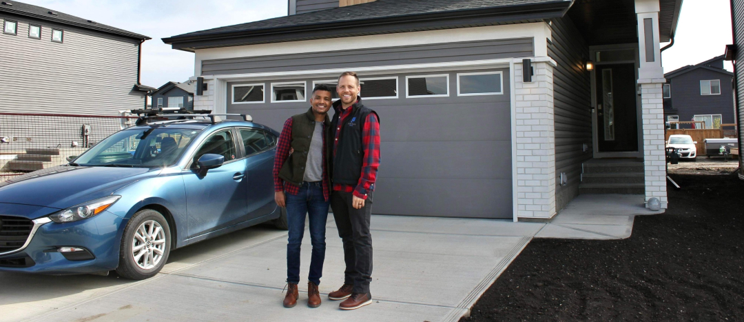 proud new homeowners smiling in front of their new home