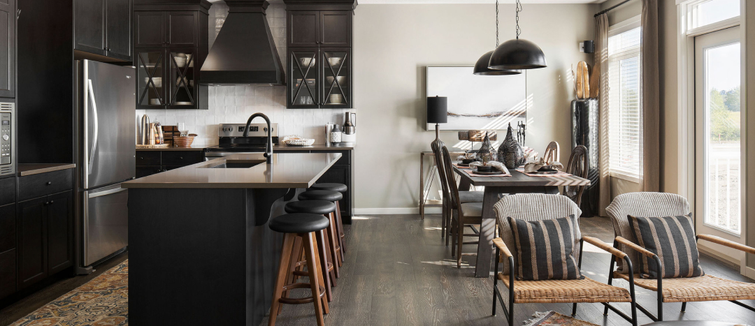 kitchen with dark cabinets, stainless steel appliances, and dining area